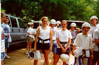 Youth prepare to climb cliff.