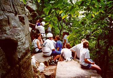 Youth wait for turns on cliff.