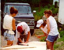 Siding is nailed to the last truss before it is positioned.